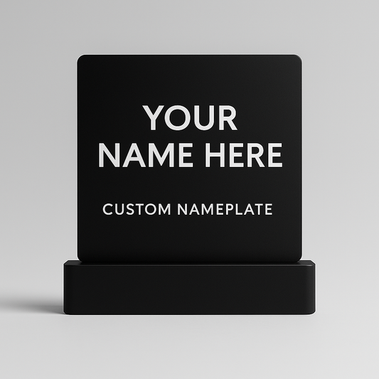 Black custom nameplate with 'Your Name Here' text on a gray background